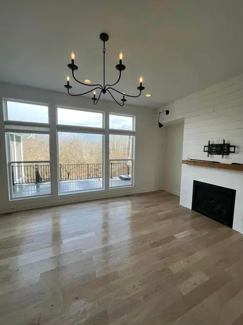 Spotless modern bedroom with natural light, freshly made bed, and clean floors in Cary NC home